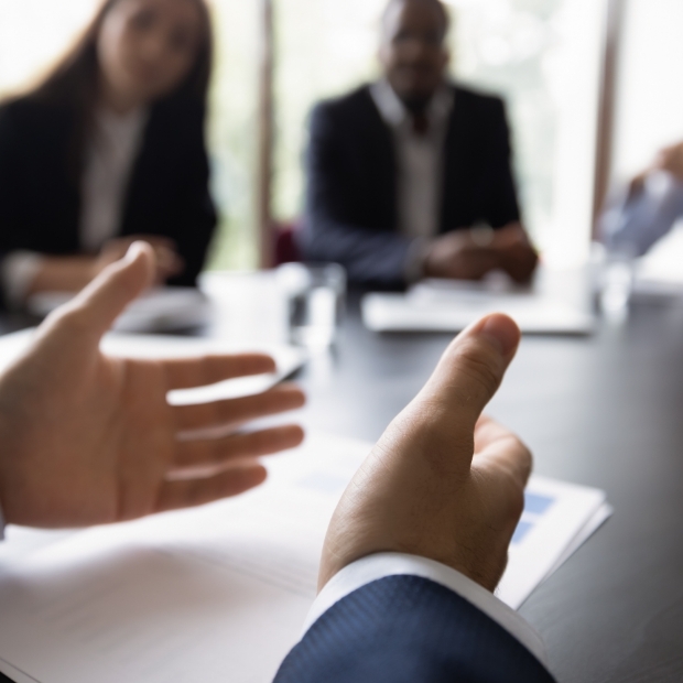 executive talking with their hands at a meeting