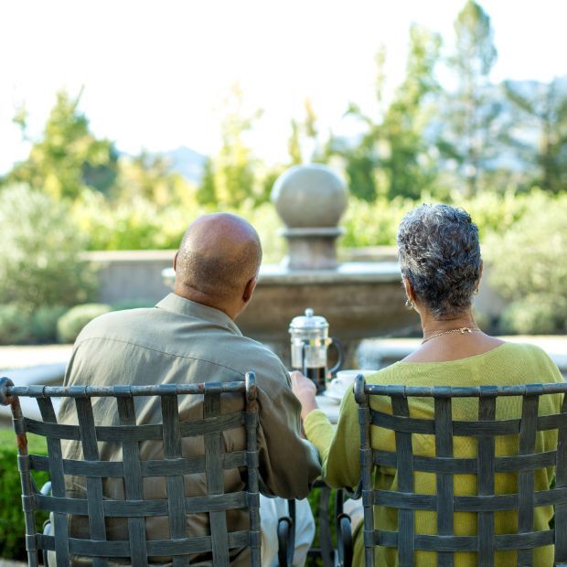 couple sitting outside, eating at a table
